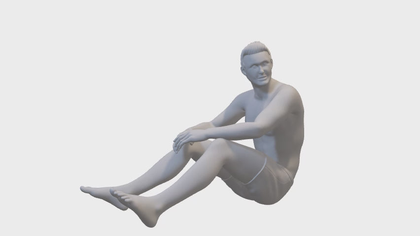 Man sitting in swimming trunks - miniature figure